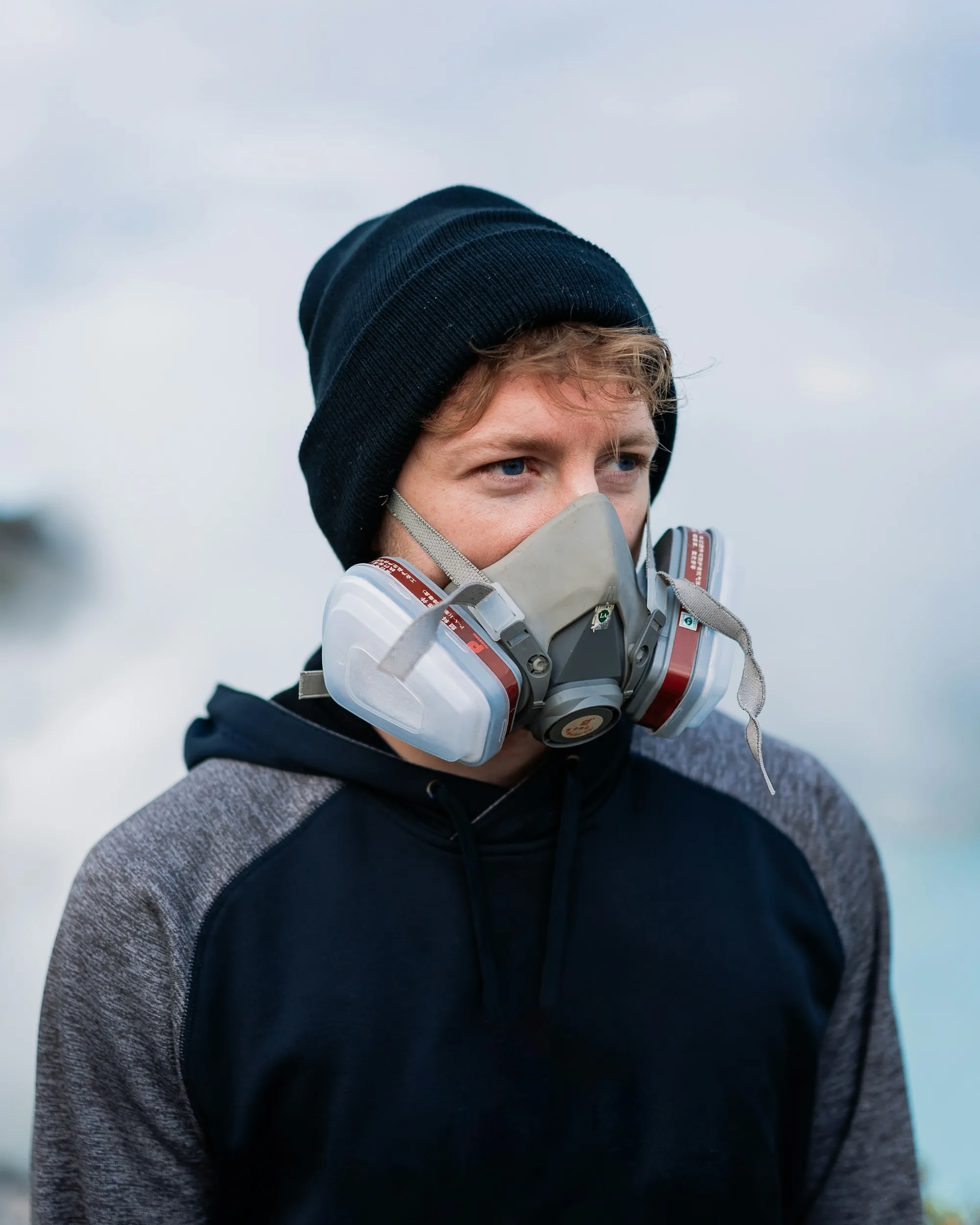 Worker wearing a half-face respirator with filter cartridges